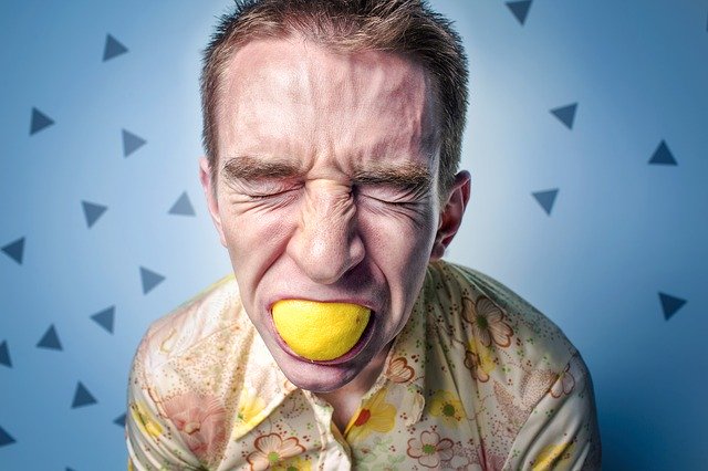 Man sucking on a lemon
