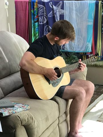 Image of author's son playing guitar