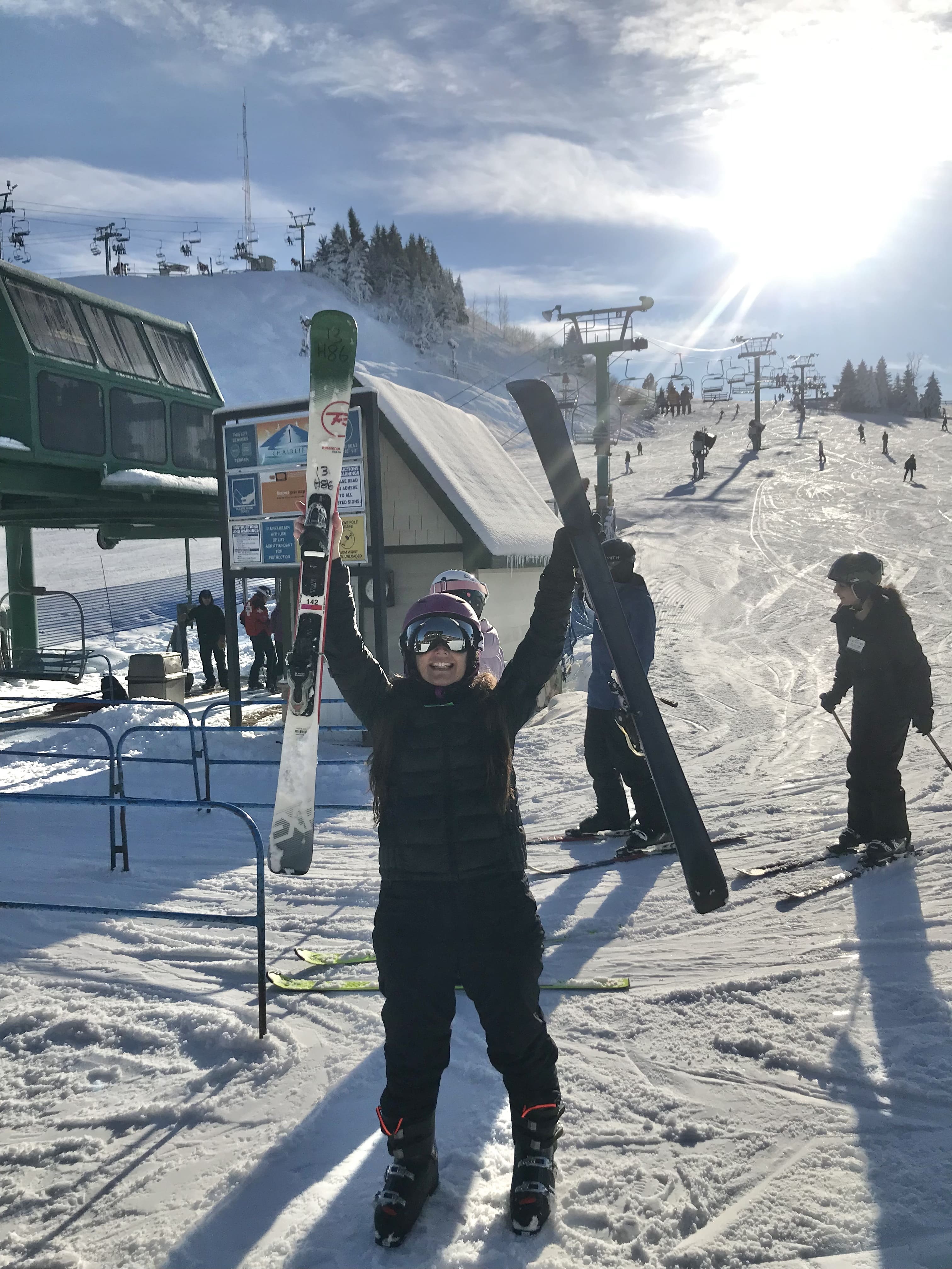 Facing your fear can mean winning: Author holding skis triumphantly